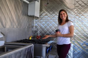 Allison Tohme, research associate for Pennington Biomedical Research Center (a Challenge Grant partner) shows off Central LA's new mobile kitchen (yes, that's inside our NOW truck)! 