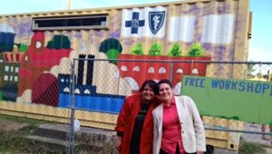 Growing LA's Marianne Cufone and BCBSLAF's Lydia Martin pose in front of the new NOLA recirculating farm container office.