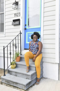 Sarah Omojola posing on front door step.