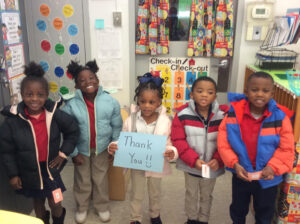 BCBS Foundation children posing with sign.