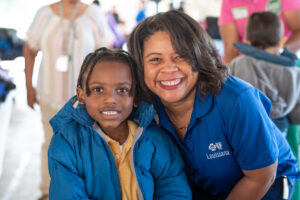 BCBS Foundation worker posing with child.